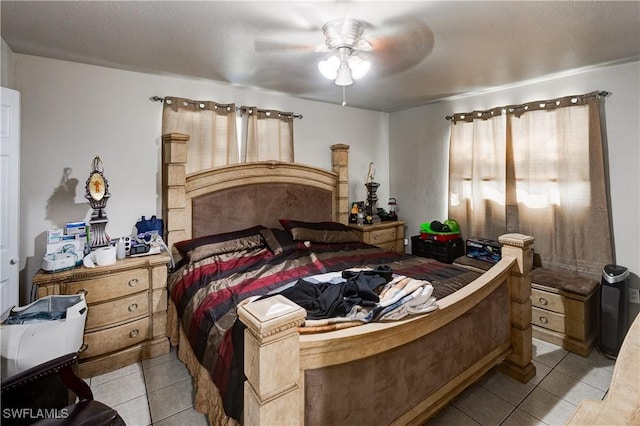 bedroom featuring light tile patterned floors and a ceiling fan