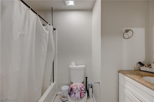 bathroom featuring shower / bath combo with shower curtain, toilet, and vanity