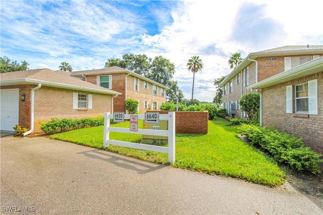 surrounding community featuring a lawn and a garage