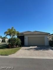 view of front of property with a garage and concrete driveway