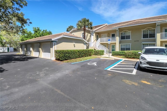 22741 Sandy Bay Dr Unit 201, Estero, FL 33928 - view of property featuring uncovered parking