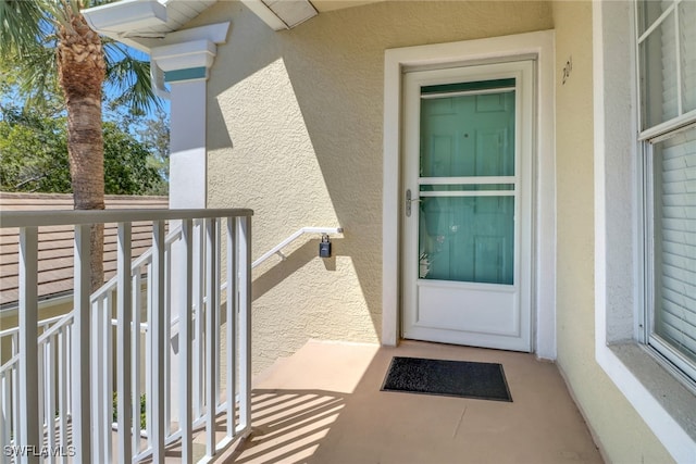 22741 Sandy Bay Dr Unit 201, Estero, FL 33928 - property entrance with stucco siding and a balcony