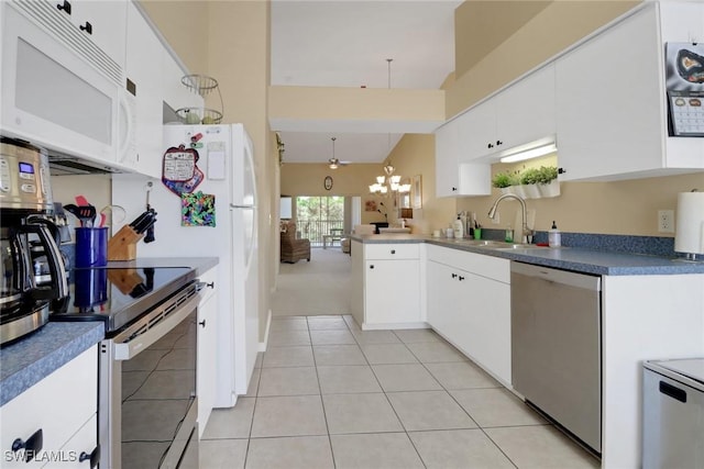 22741 Sandy Bay Dr Unit 201, Estero, FL 33928 - kitchen featuring a sink, appliances with stainless steel finishes, light tile patterned floors, and white cabinetry