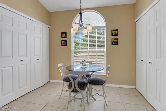 22741 Sandy Bay Dr Unit 201, Estero, FL 33928 - dining area featuring baseboards, a notable chandelier, and light tile patterned flooring