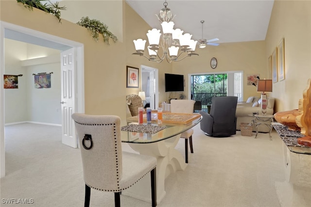 22741 Sandy Bay Dr Unit 201, Estero, FL 33928 - carpeted dining space with ceiling fan with notable chandelier, baseboards, and a towering ceiling