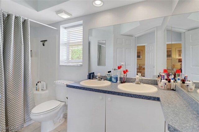 22741 Sandy Bay Dr Unit 201, Estero, FL 33928 - full bathroom featuring a sink, curtained shower, toilet, and tile patterned flooring