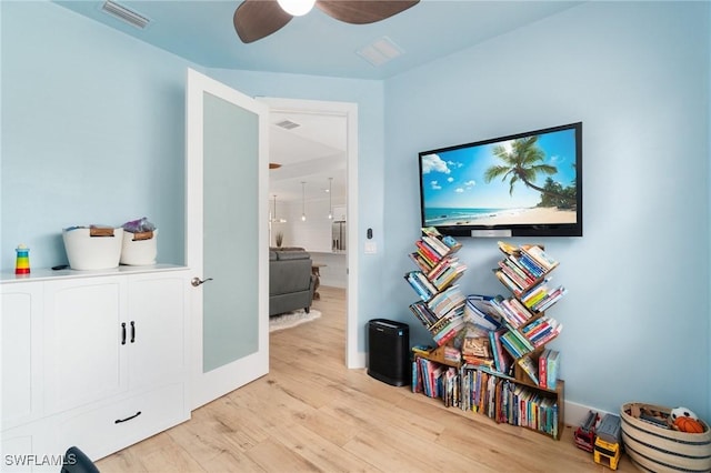 interior space with visible vents, ceiling fan, and light wood finished floors