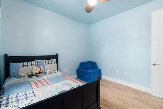 bedroom featuring light wood-type flooring, ceiling fan, and baseboards