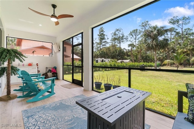 sunroom with a ceiling fan