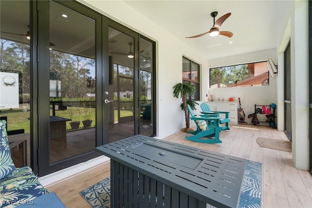 sunroom with a ceiling fan