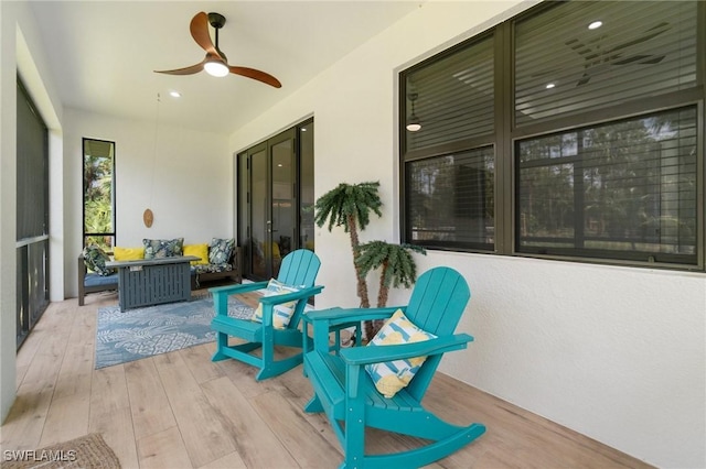 sunroom featuring ceiling fan