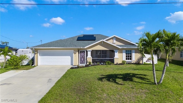 ranch-style house featuring an attached garage, driveway, roof mounted solar panels, stucco siding, and a front lawn