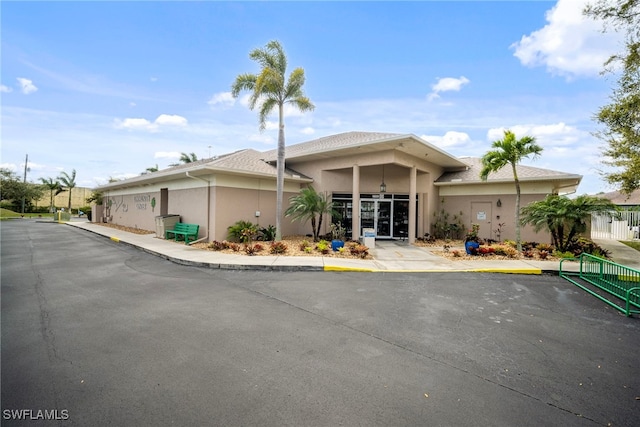 view of front of property with fence and stucco siding