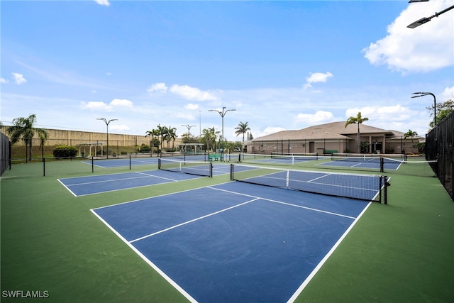 view of sport court featuring fence