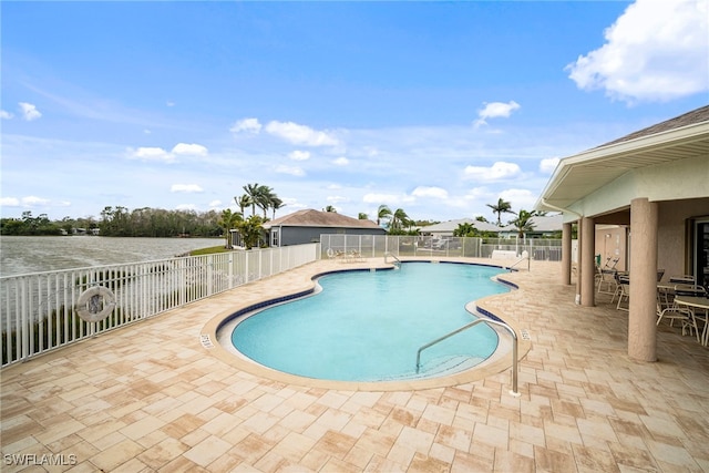 community pool featuring a patio area and fence