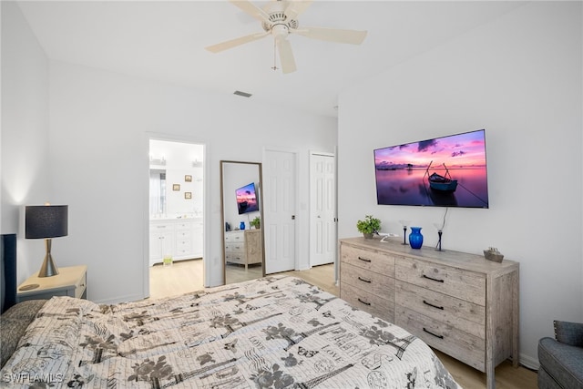 10735 Blue Bimini Cir, Estero, FL 33928 - bedroom featuring light wood-type flooring, connected bathroom, and a ceiling fan
