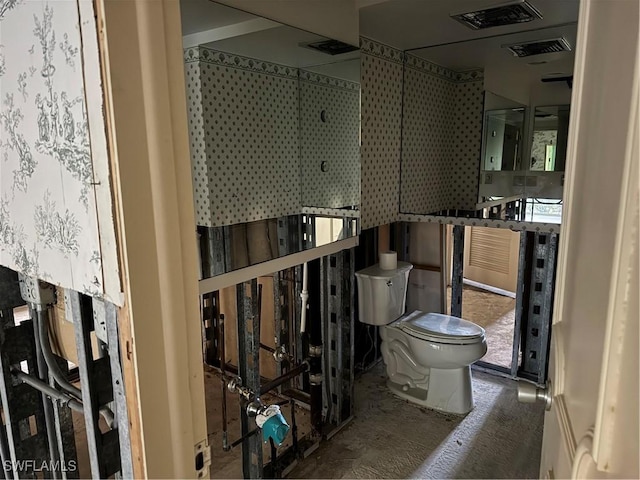 bathroom with visible vents and toilet