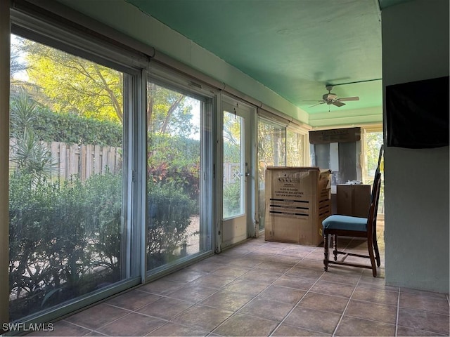 sunroom / solarium featuring ceiling fan