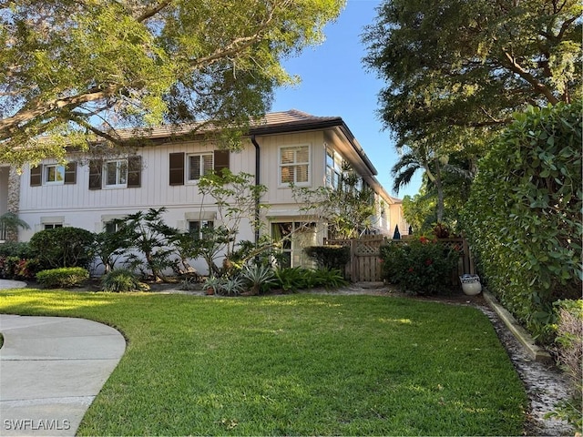 view of front of property with a front yard and fence