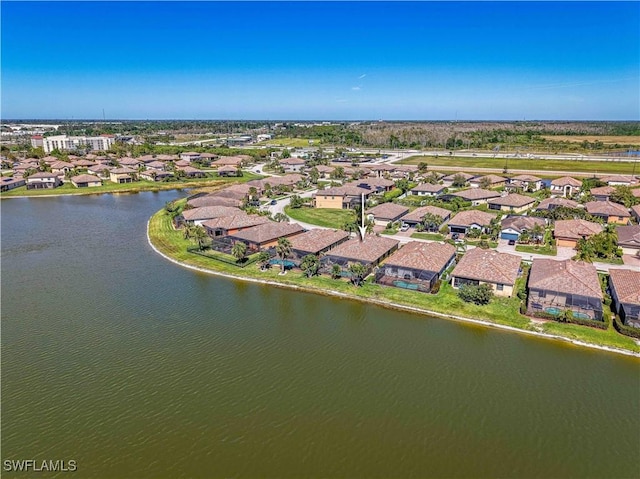 birds eye view of property featuring a water view and a residential view