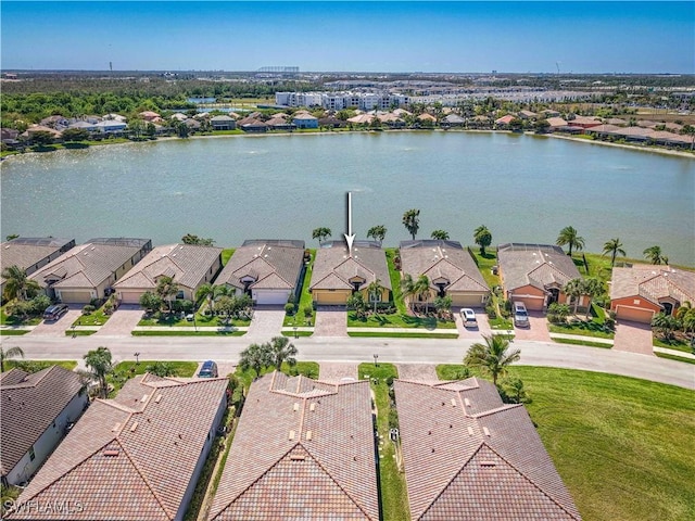 drone / aerial view featuring a residential view and a water view