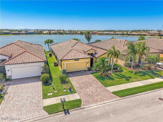 2877 Via Piazza Loop, Fort Myers, FL 33905 - view of front of property with an attached garage, stucco siding, and a water view