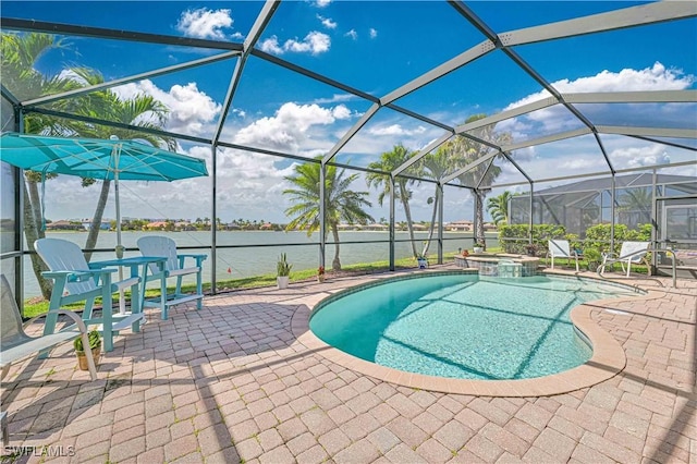 view of pool featuring a pool with connected hot tub, a patio area, a water view, and a lanai