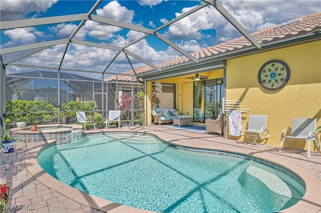 view of pool with a lanai, a patio area, a pool with connected hot tub, and an outdoor living space