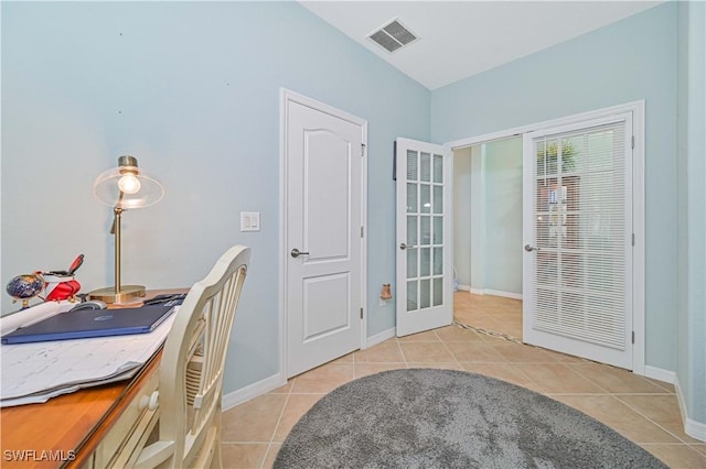 office space featuring light tile patterned floors, french doors, visible vents, and baseboards