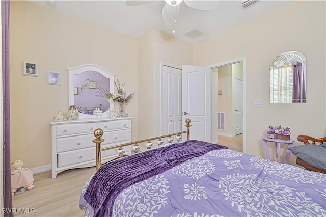 bedroom with light wood-style floors, baseboards, visible vents, and a ceiling fan