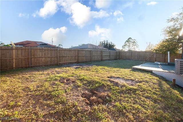 view of yard with a fenced backyard and a wooden deck