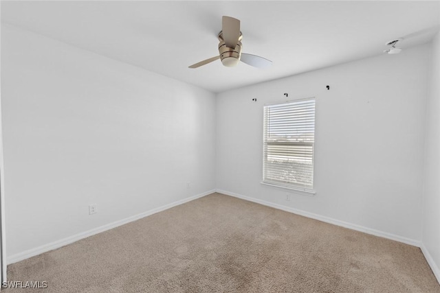 unfurnished room featuring a ceiling fan, baseboards, and carpet floors