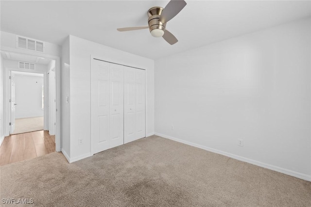 unfurnished bedroom featuring baseboards, visible vents, carpet floors, and a closet