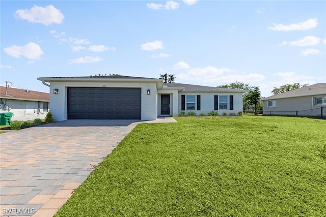 ranch-style home with stucco siding, a front yard, decorative driveway, and a garage