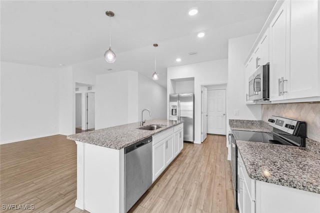 kitchen with backsplash, light wood-style flooring, appliances with stainless steel finishes, white cabinets, and a sink