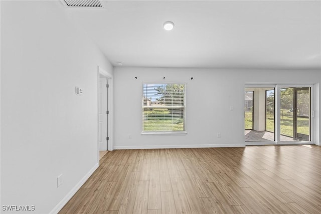 spare room featuring visible vents, baseboards, and light wood-type flooring