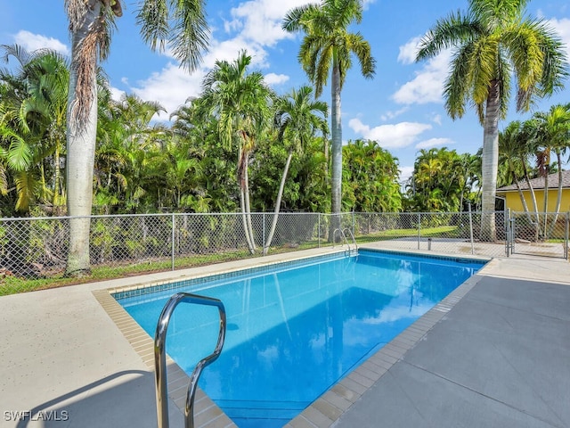 view of swimming pool with a fenced in pool and fence