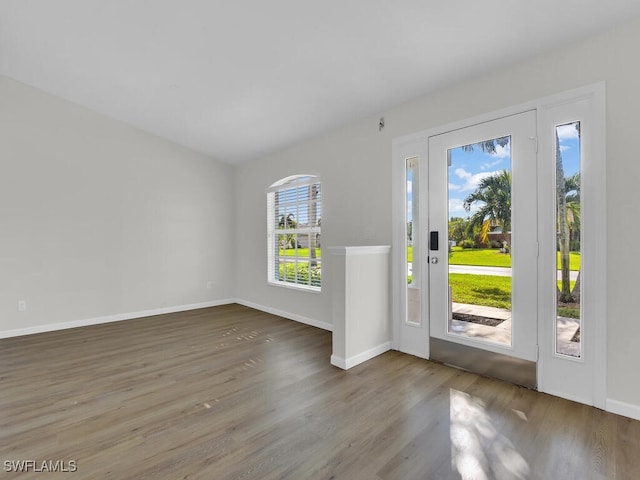 foyer with baseboards and wood finished floors