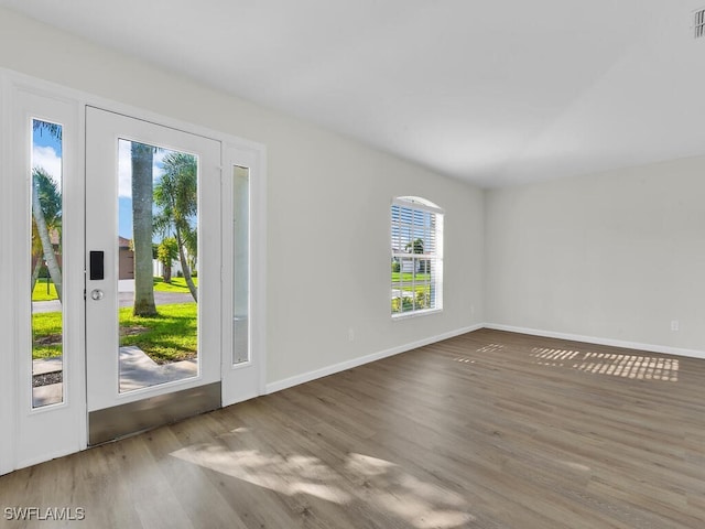 interior space with visible vents, baseboards, and wood finished floors