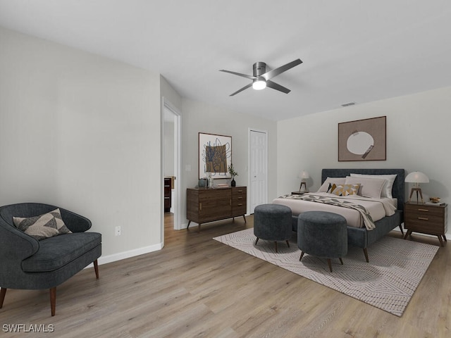 bedroom with a closet, visible vents, light wood-style flooring, a ceiling fan, and baseboards