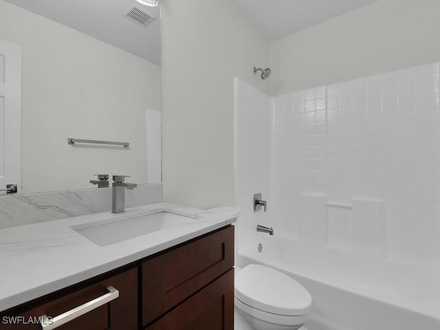 bathroom with visible vents, tub / shower combination, vanity, and toilet