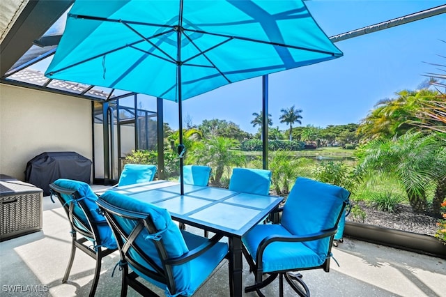 view of patio / terrace with outdoor dining space, glass enclosure, and area for grilling