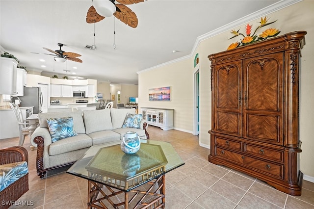 living area with visible vents, ornamental molding, a ceiling fan, light tile patterned floors, and baseboards