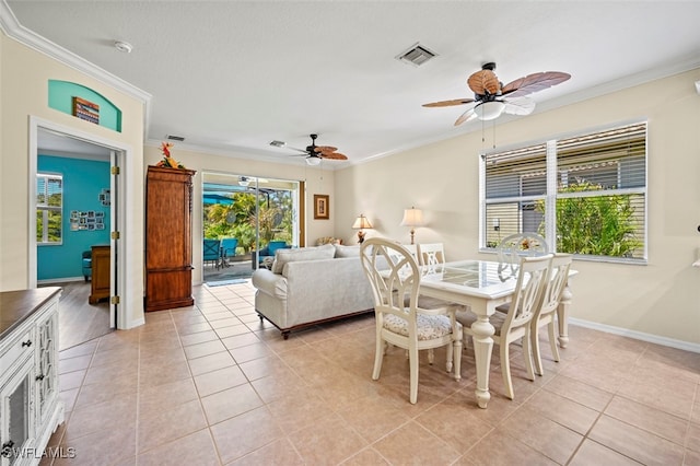 dining room with crown molding, light tile patterned floors, and visible vents