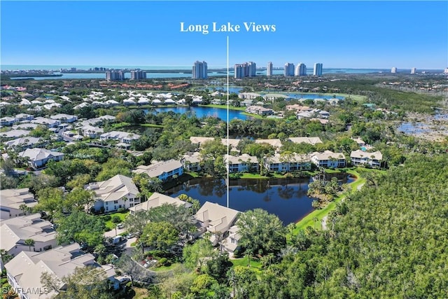 drone / aerial view featuring a water view and a view of city