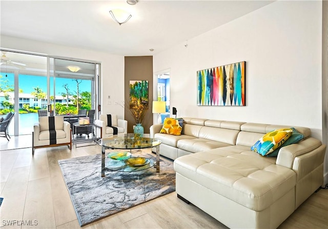 27091 Lake Harbor Ct Unit 102, Bonita Springs, FL 34134 - living room with a ceiling fan and wood finished floors