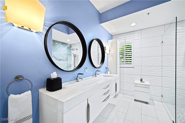 bathroom with a sink, tile walls, double vanity, and tile patterned floors