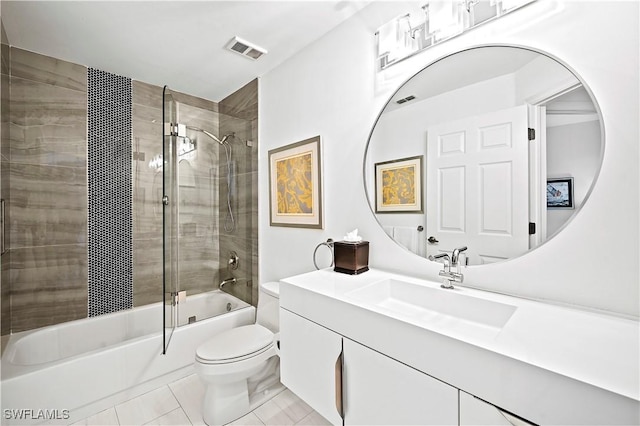 full bath featuring visible vents, bath / shower combo with glass door, toilet, tile patterned floors, and vanity