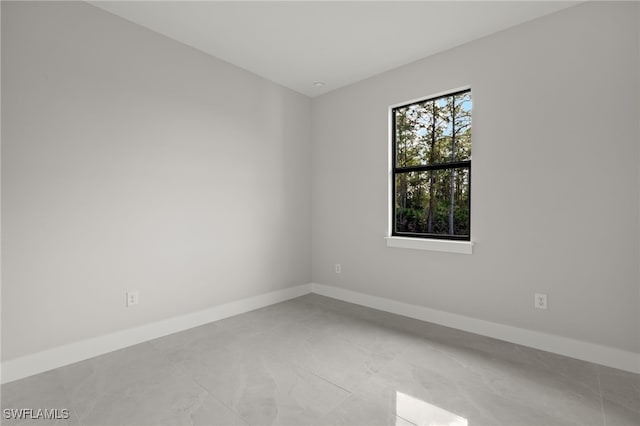 unfurnished room featuring baseboards