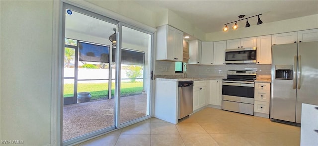 kitchen featuring tasteful backsplash, white cabinets, and stainless steel appliances